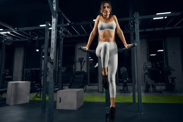 woman-posing-parallel-bars-gym