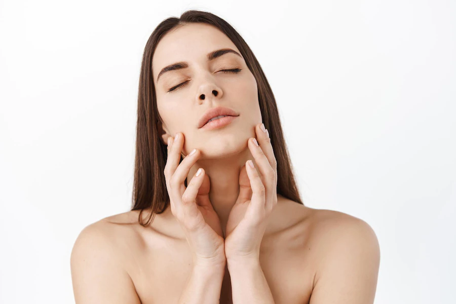 beautiful-young-woman-with-clean-perfect-skin-portrait-beauty-model-with-natural-make-up-touching-her-face-spa-skincare-wellness-close-up-white-background-copyspace